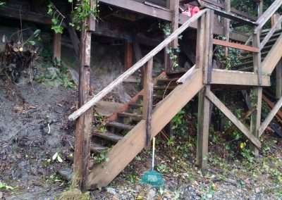 An old wooden staircase with a dilapidated lattice.